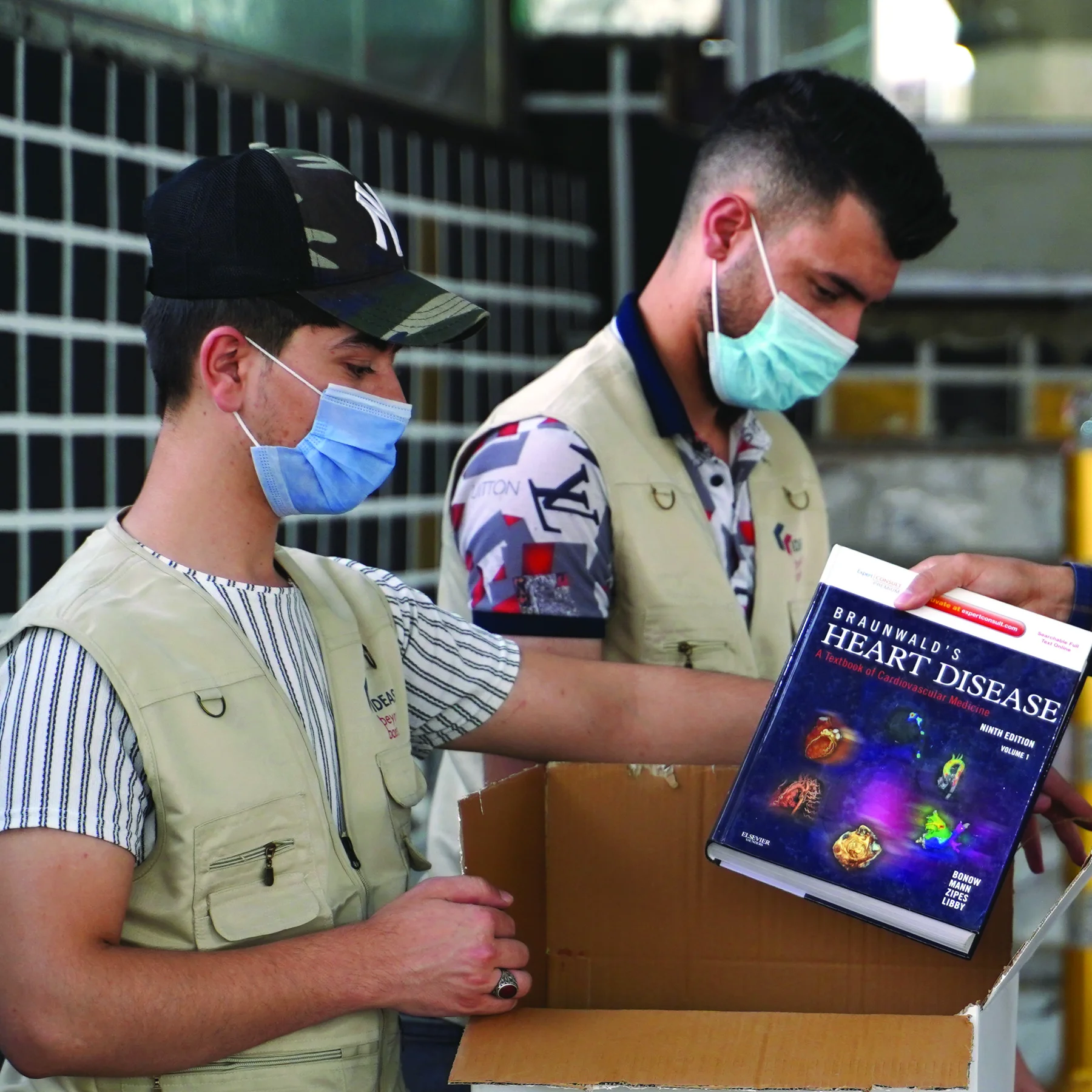 Members of the project team carrying a box of books